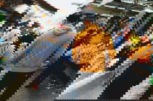 A couple strolling through a vibrant market in Israel.