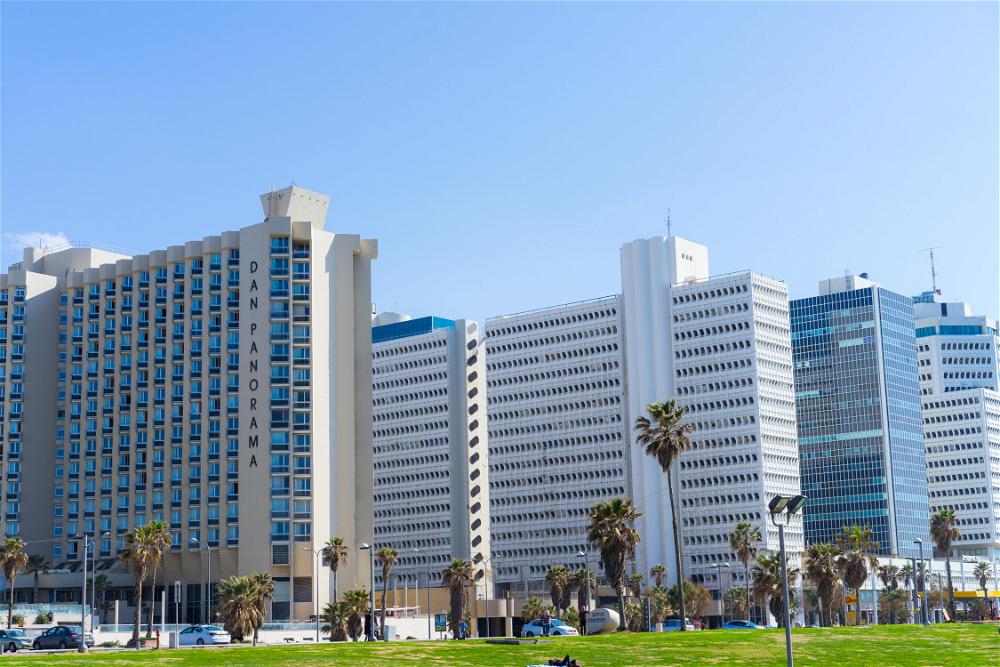 The backdrop of buildings behind the grass in Charles Clore Park, Tel Aviv