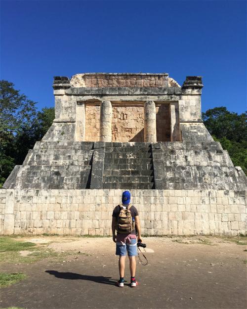 Man admiring ancient Mayan ruins at Chichen Itza, Mexico