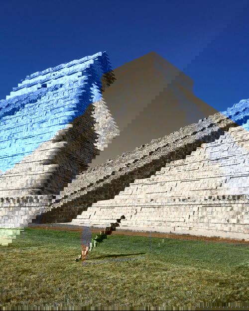 Woman with the biggest pyramid at Chichen Itza national park in the Yucatan, Mexico
