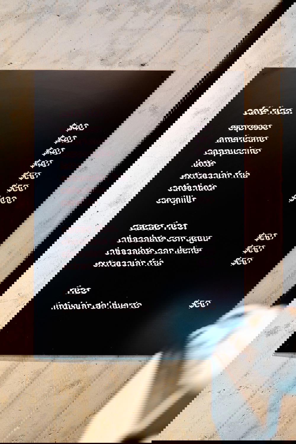 A menu is displayed on the wall of a Mexican restaurant.