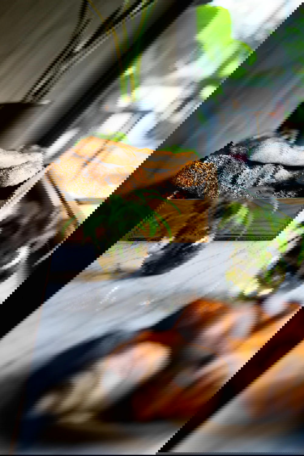 Wooden box of freshly baked bread on a quartz countertop for a cafe display window