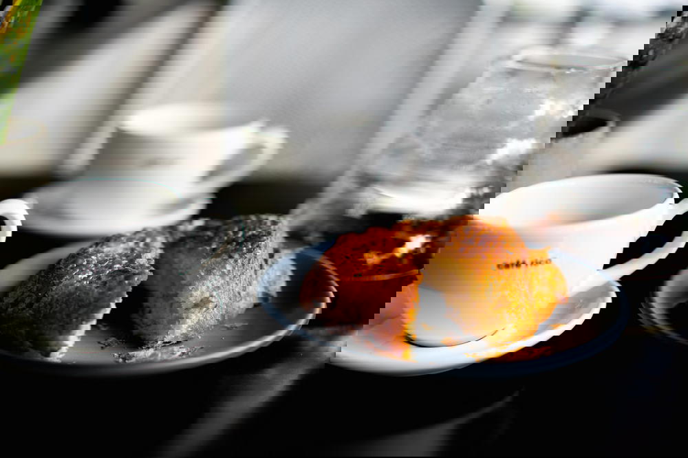 A cup of Mexican coffee and a croissant on a table.