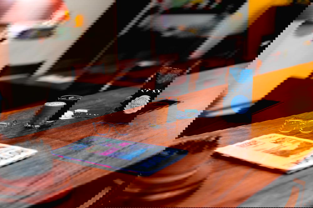 A wooden table with a coffee cup and a newspaper, illustrating the vibrant culture of Mexico.