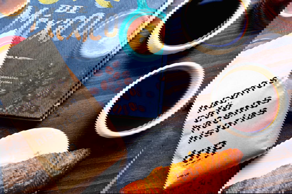 Two small white cups of black coffee, a croissant on a white plate and a brown paper bag of craft coffee in Mexico City Drip Cafe