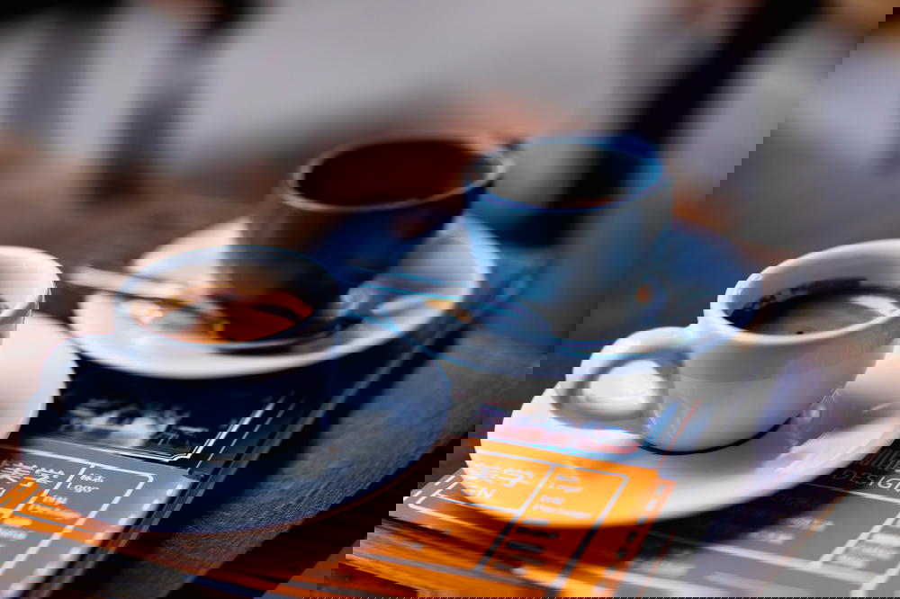 Two cups of Mexican coffee on a wooden table.