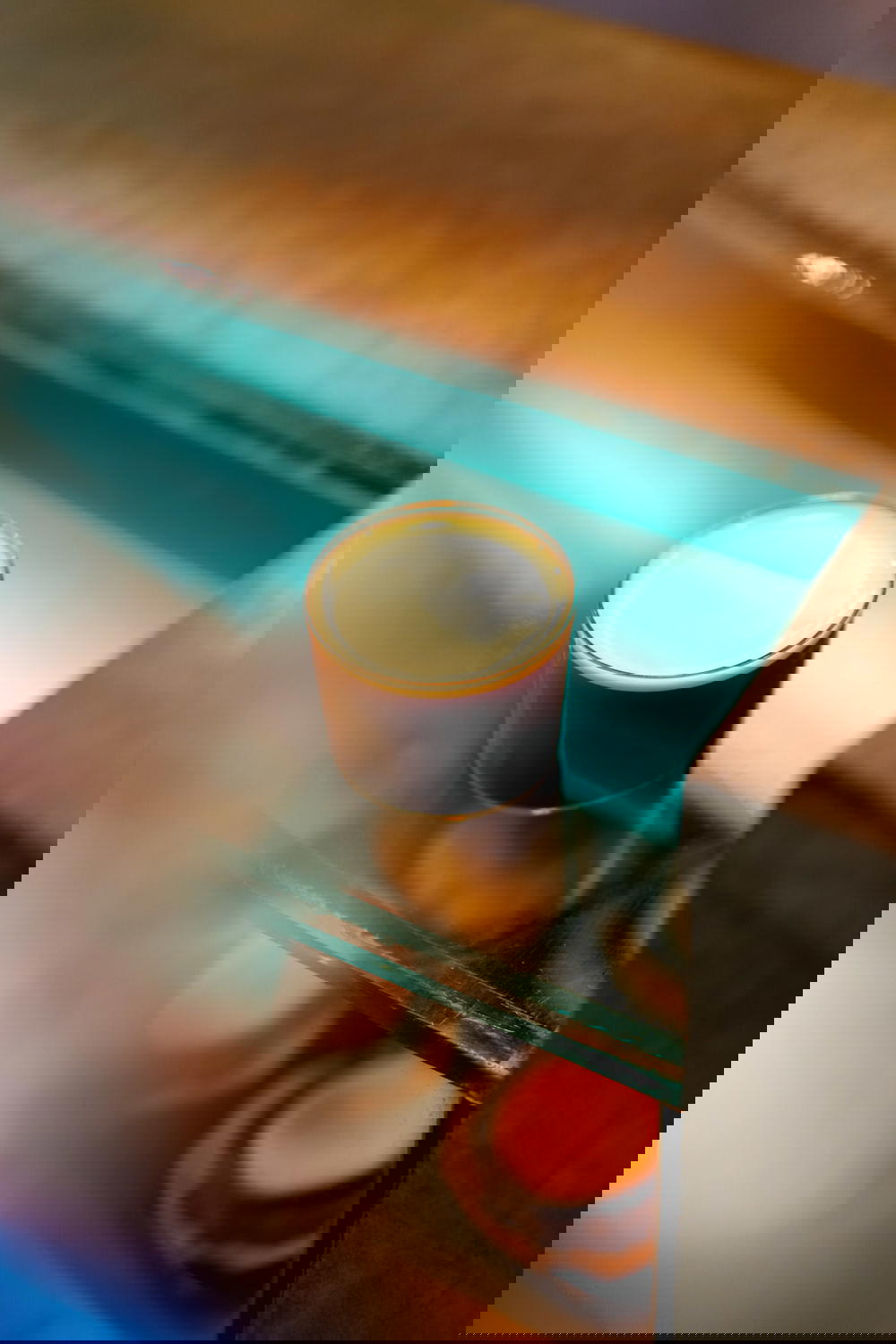 Low delicate glass of nitro brew coffee on a glass countertop at Almanegra cafe