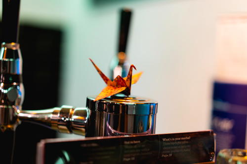 A Mexican-inspired beer tap adorned with a vibrant flower.