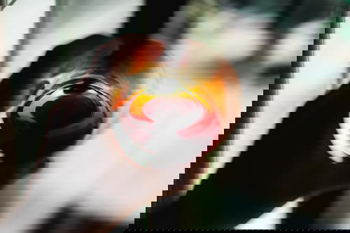 A person holding a glass of wine in front of a window in Mexico.