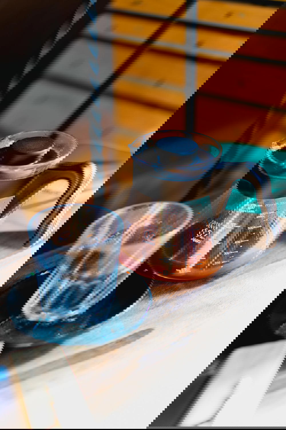 A coffee pot on a table in Mexico next to a cup of coffee.