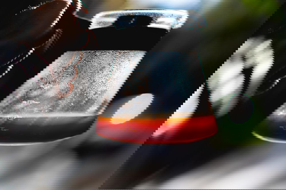 A person holding a glass of Mexican coffee.