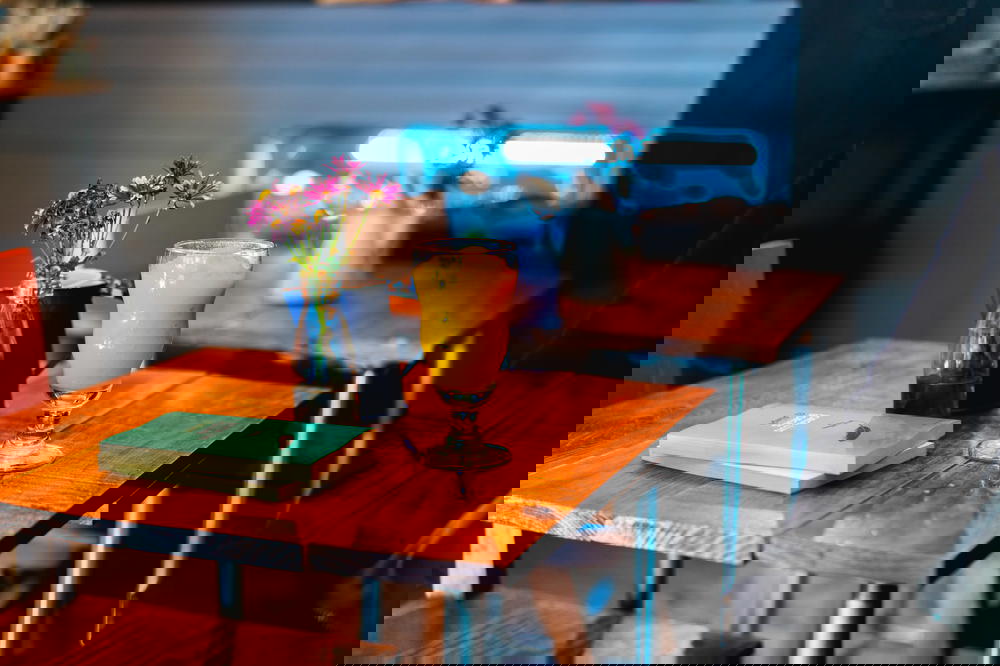 A man sitting at a table with a glass of orange juice in Mexico.