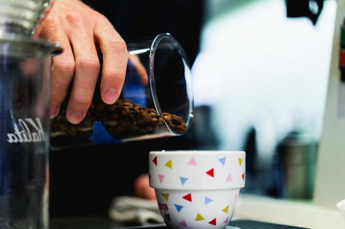 A person pouring Mexican coffee into a cup.