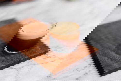 A glass of espresso on a Mexican wooden cutting board.