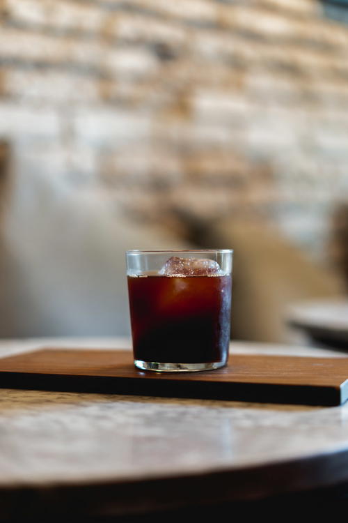 A glass of Mexican coffee on a wooden table.