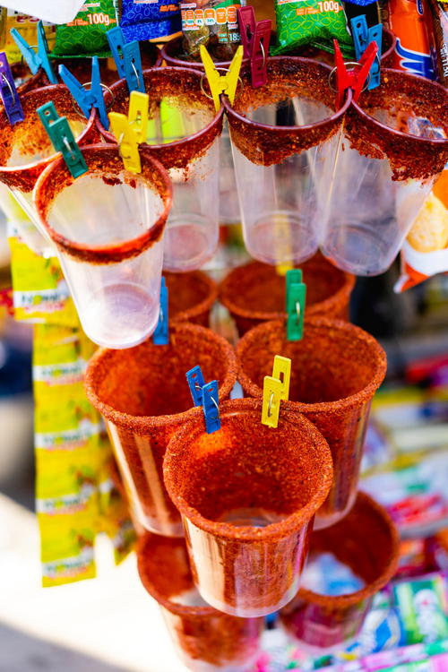 Plastic cups hanging from a hook in Mexico.