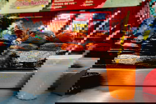 A counter with a cup of orange juice from Mexico.