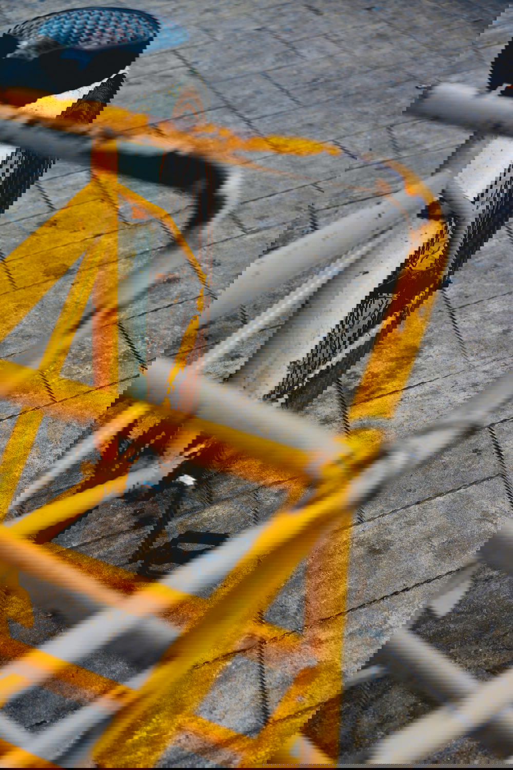 A yellow bicycle parked on a sidewalk in Mexico.
