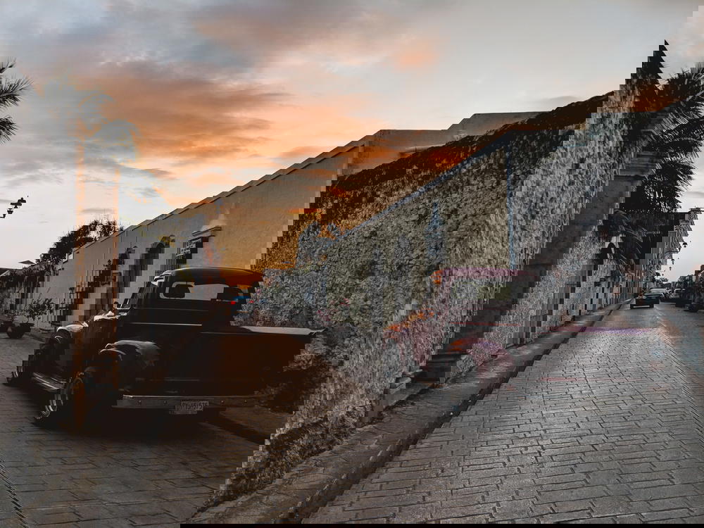 Sunset on a street with a red truck