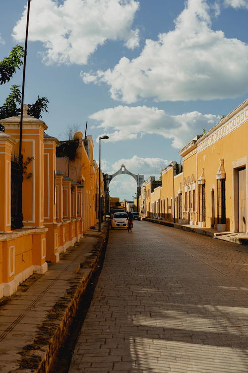 A street lined with yellow buildings in Mexico.