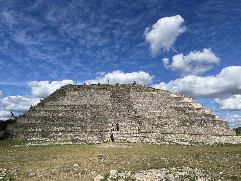 A pyramid in Izamal, Mexico, situated amidst a grassy field.