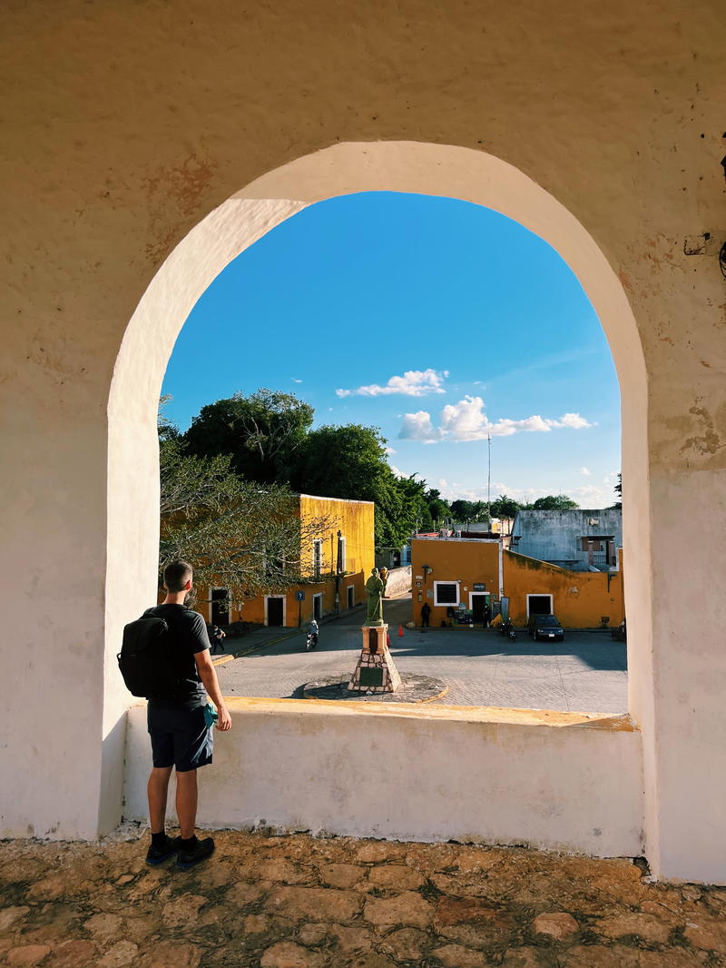 A man looking out of an archway in the town of Izamal, Mexico.