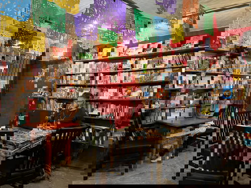 A man sits at a table in a bookstore in Merida, Mexico.