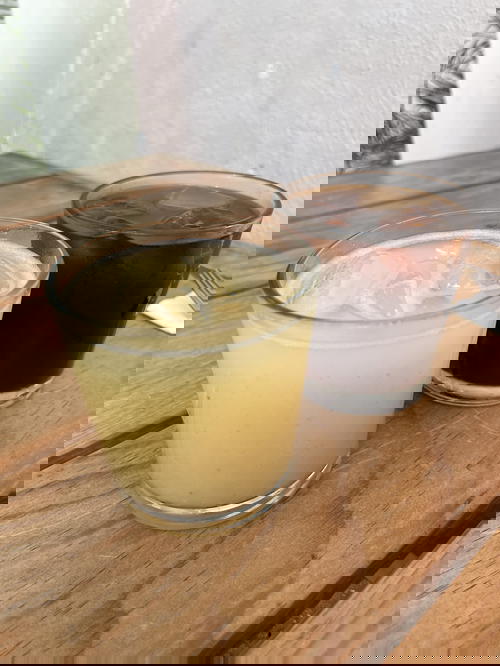 Two glasses of drinks on a wooden table in Merida, Mexico.
