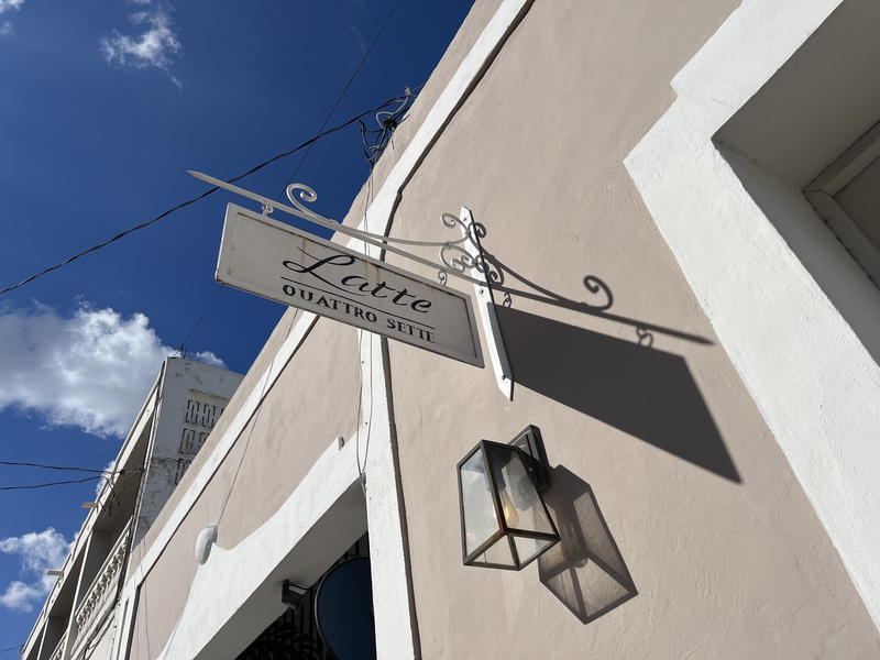 A sign with blue sky backdrop in Merida, Mexico.