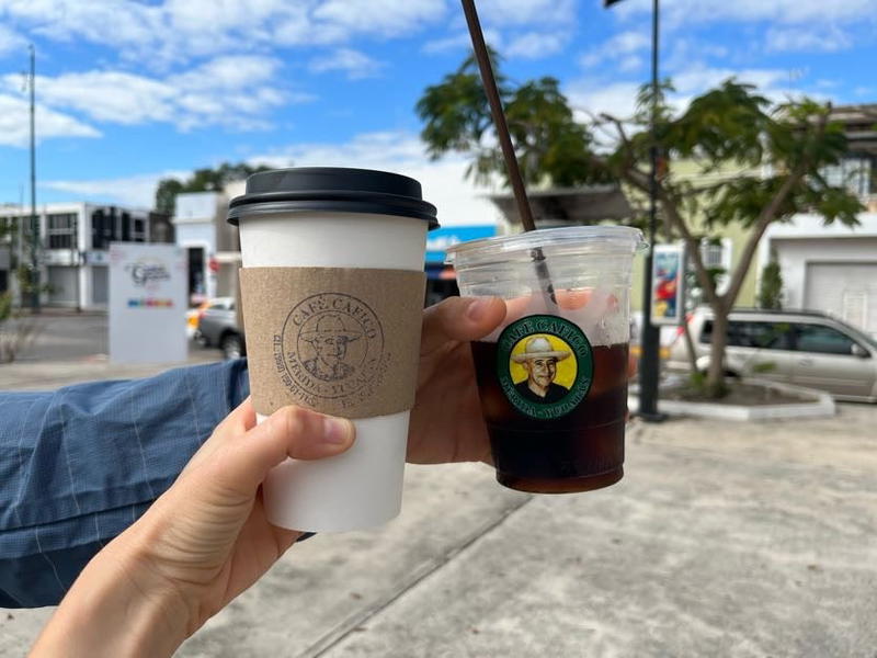 Two people holding a cup of coffee in Merida, Mexico.