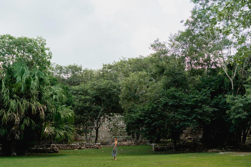 A woman is standing in a grassy area in Merida, Mexico.