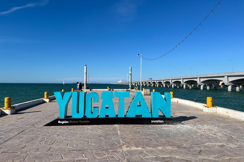 A Yucatan sign in front of the ocean in Mexico.