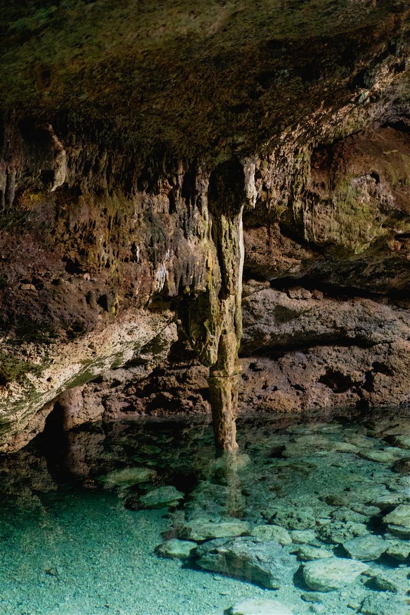 A cave with clear water and a rock formation located in Merida, Mexico.