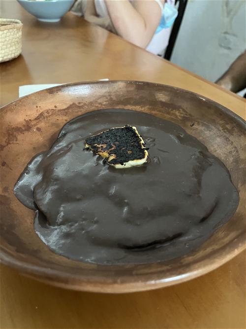 A bowl of chocolate pudding on a wooden table in Merida, Mexico.