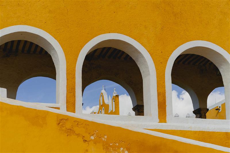 A yellow building with arches in Merida, Mexico.