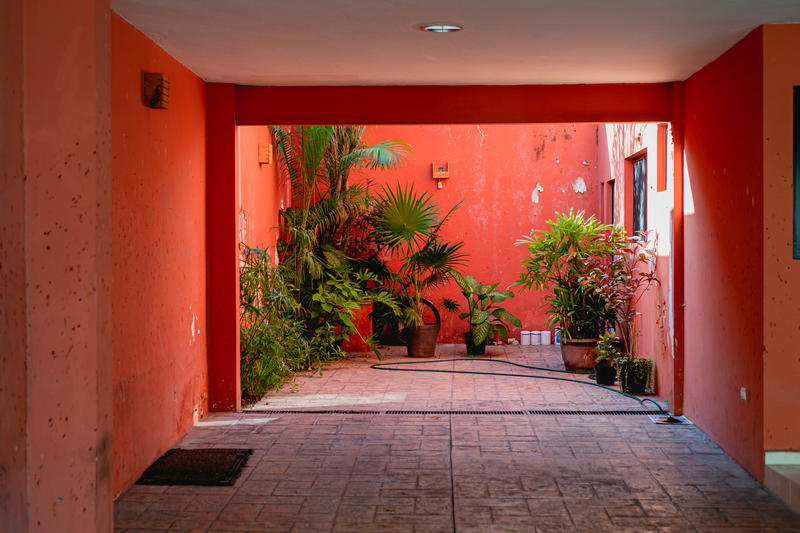 A hallway leading to a room with a window in Merida, Mexico.
