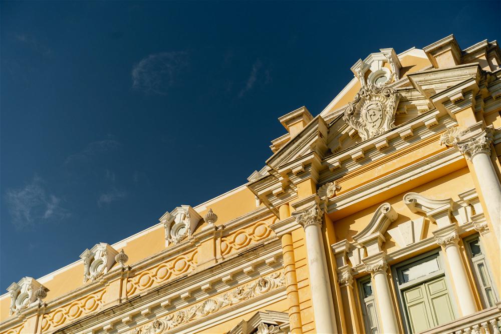 An ornate building in Merida, Mexico with a blue sky behind it.