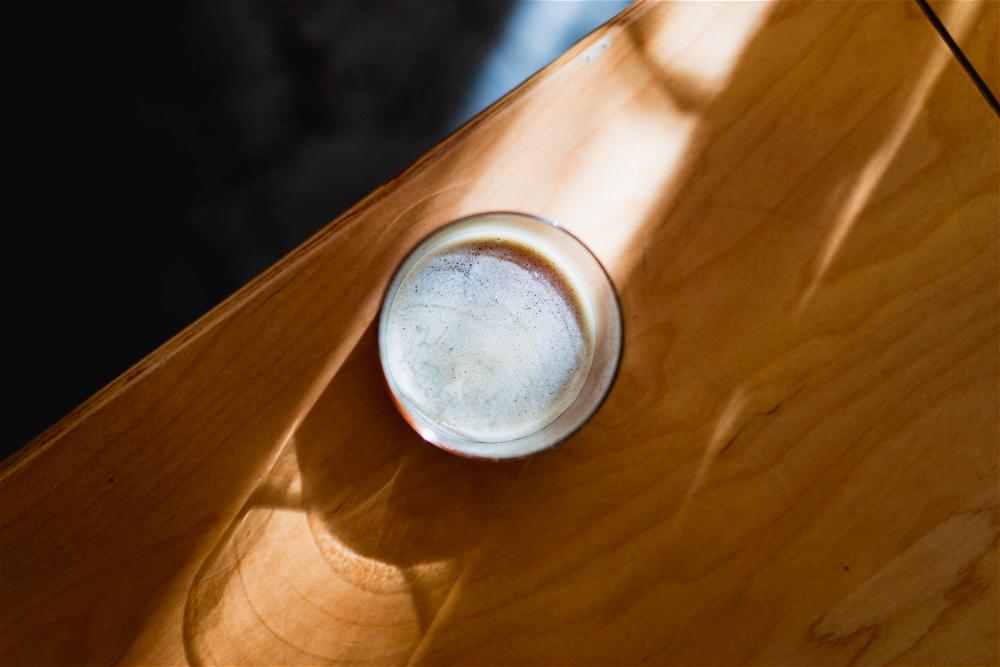 A glass on top of a wooden table in Mexico City.