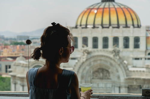 A woman looking out of a window in Mexico City.