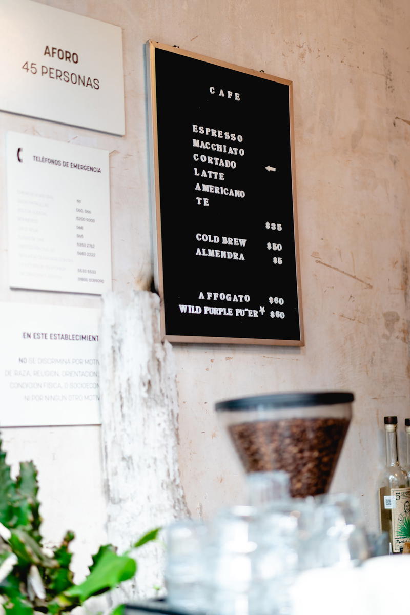A coffee shop in Mexico City with a menu on the wall.