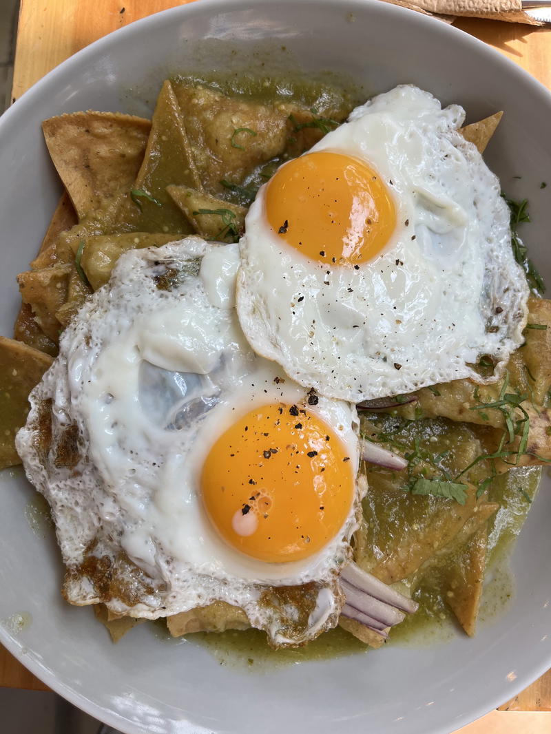 A bowl of food topped with a Mexican-style fried egg.