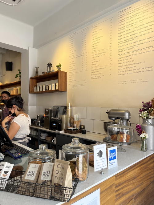 A coffee shop in Mexico City with a counter and people at the counter.