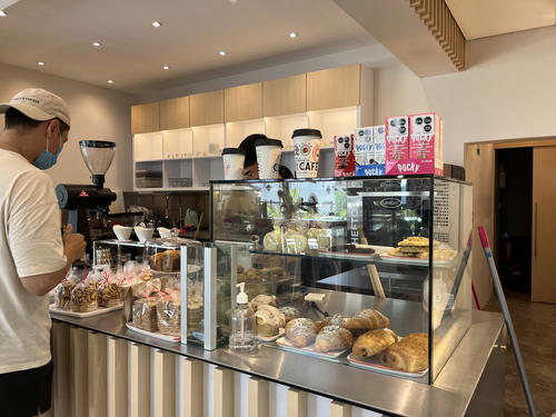 A man is standing at the counter of a coffee shop in Mexico City.