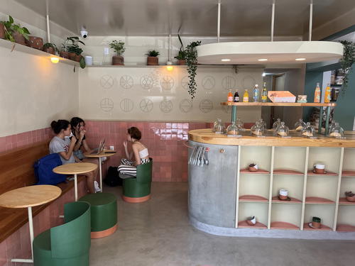 The interior of a coffee shop in Mexico City with people sitting at tables.