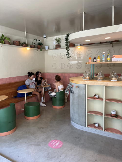 The interior of a coffee shop in Mexico City with people sitting at the counter.