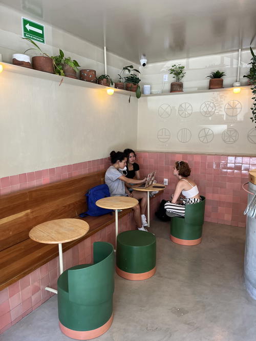 Two women sitting at a table in a coffee shop in Mexico City.