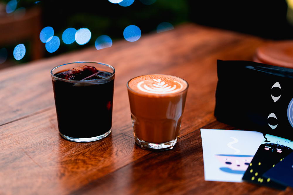 A cup of exquisite Mexican coffee and a soothing cup of tea elegantly placed on a wooden table at Blend Station.