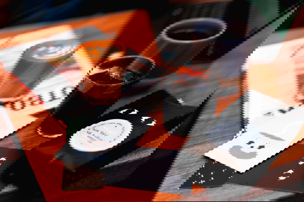 A cup of Mexico City coffee and a notebook on a blend station table.