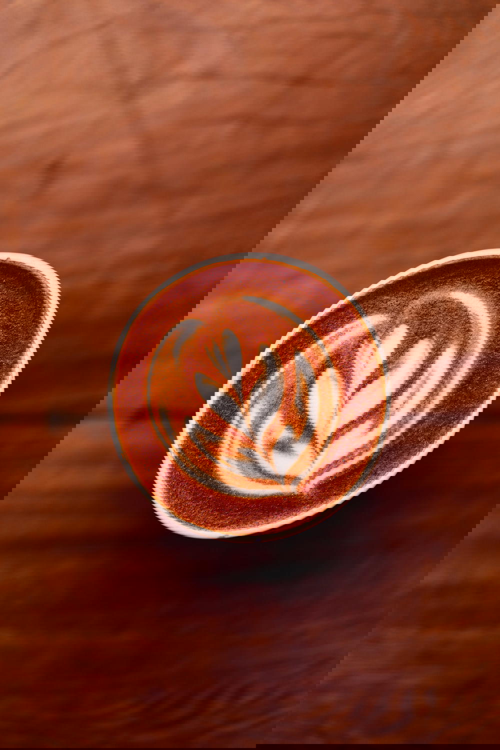 Latte art displayed on a wooden table at Blend Station in Mexico City.