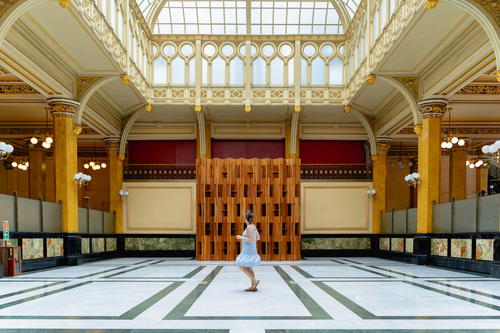 a woman in a white dress standing in a large room